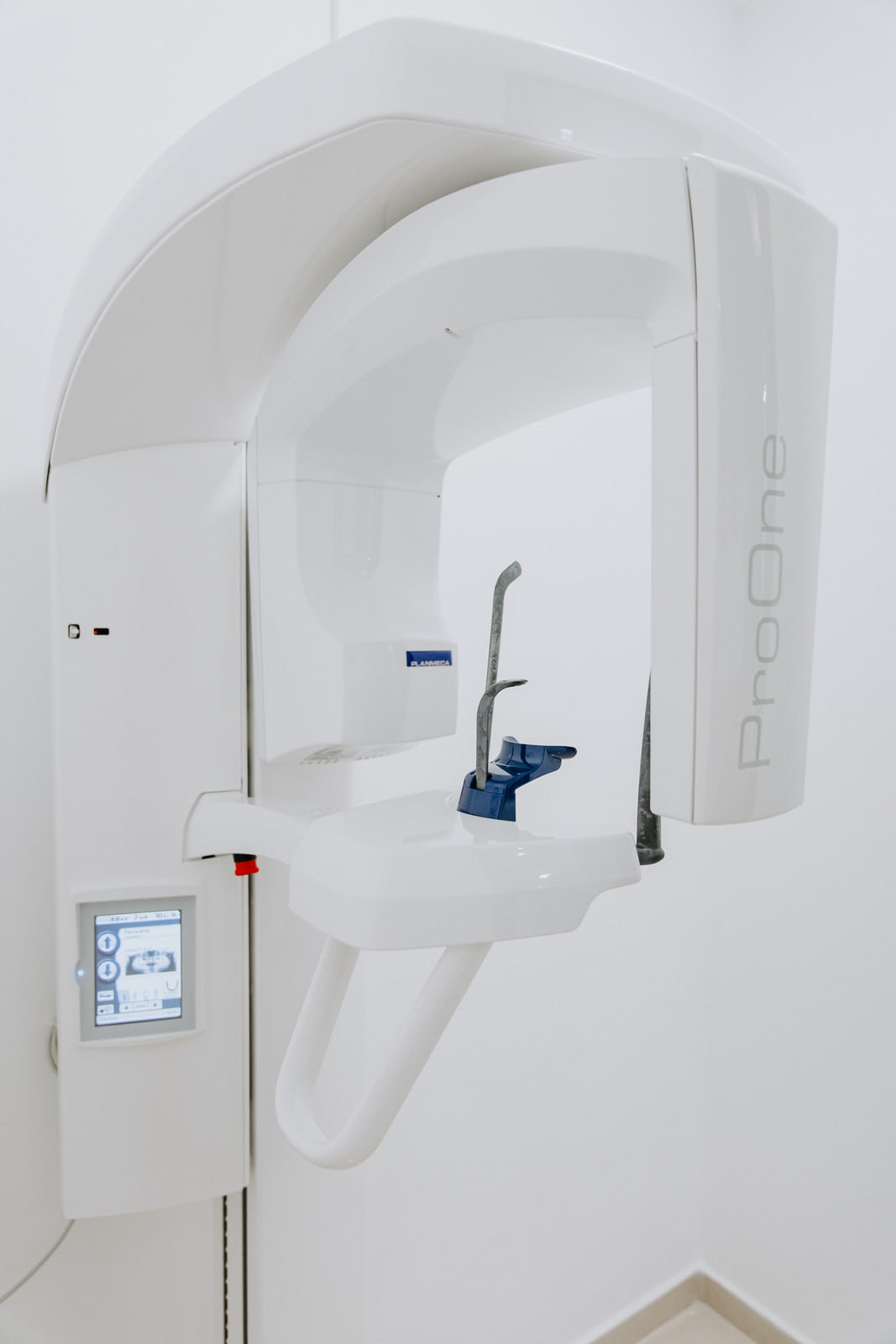 The panoramic X-ray unit standing against a white wall